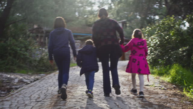 Family with three children enjoying natural beauty and clean air outdoors in a touristic village