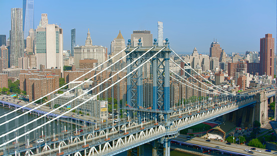 Aerial view of Manhattan Bridge over East River surrounded by skyscraper buildings, New York City, New York State, USA.