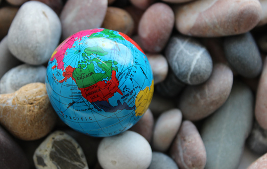 Closeup view of North and South America continents mapped on a globe with ocean routes