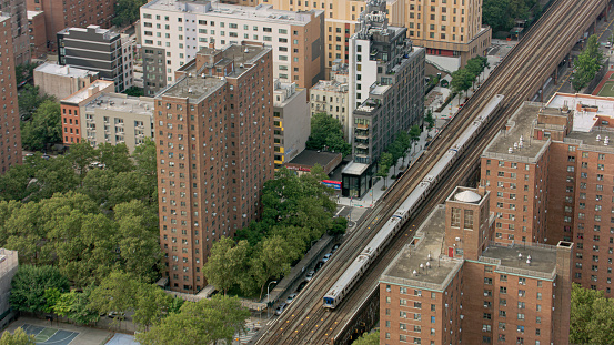 Aerial view of passenger train moving on railway track in city, New York City, New York State, USA.
