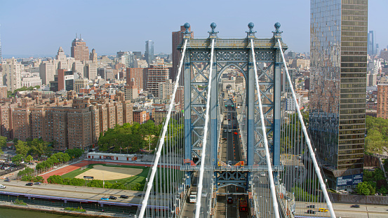 Aerial view of Manhattan Bridge in front of financial district of Manhattan surrounded by skyscraper buildings, New York City, New York State, USA.