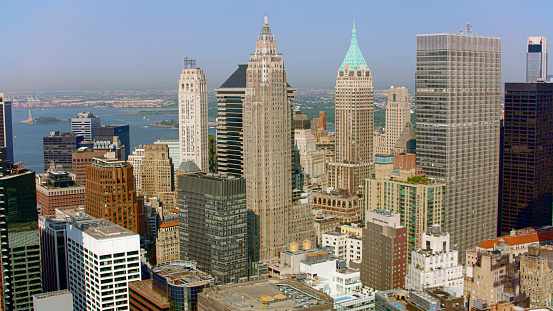 Aerial view of 70 Pine Street and 40 Wall Street surrounded by modern skyscraper in New York City, New York State, USA.