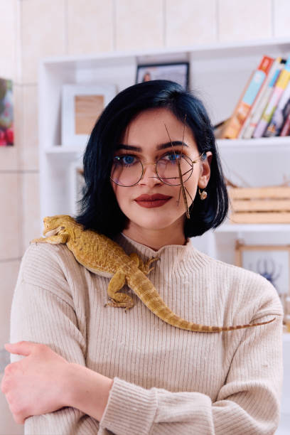 istock Woamn and Her Pets: A Bearded Dragon and a Stick Insect 2096411412