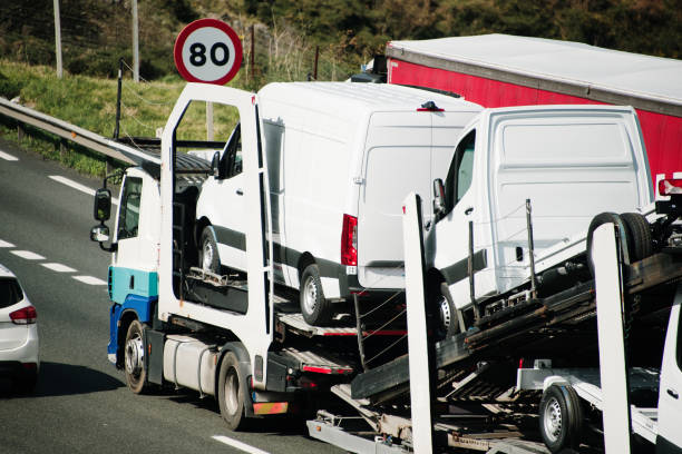 istock Truck carrying vans 2096414125