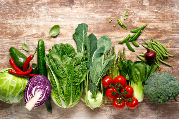 Vegetables background. Various vegetables on kitchen table. Clean eating, healthy food concept, flat lay, top down view