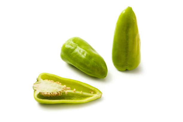 Two whole and half of green bell pepper (capsicum) known as sweet bell pepper, paprika isolated on white background. Vegetables collection.