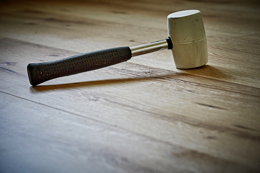 Rubber hammer, sledgehammer on the wooden floor