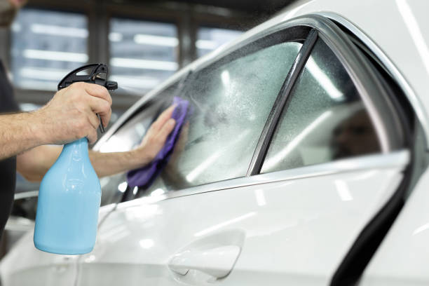 istock Car window tinting series : Spraying water on window surface. 2096467747