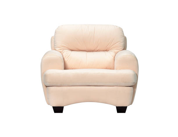 Stylish empty armchair standing in the corner of a room with wallpapered walls