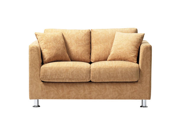 Sofa with pillow against a white wall trending Peach color.
