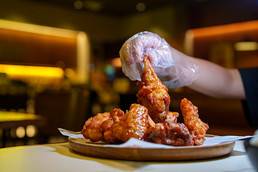 Korean fried chicken is typically involves deep-frying chicken pieces and then coating them in a sauce, which can vary from sweet and spicy to tangy or garlicky.