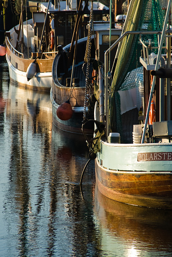 Spieka Neufeld, Germany – August 20, 2014: several boats tied up at a dock near the shore line
