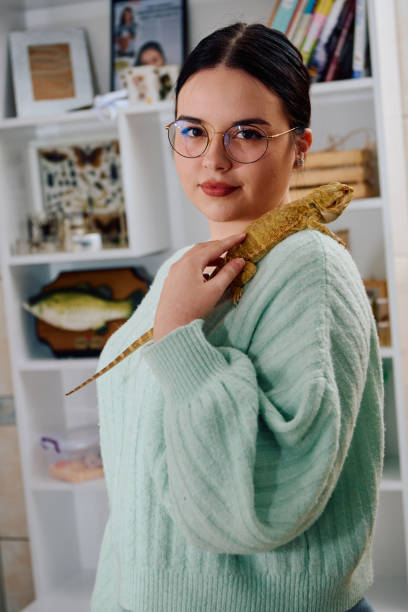 istock Beautiful Woman Posing with Her Adorable Bearded Dragon Pets 2096482002