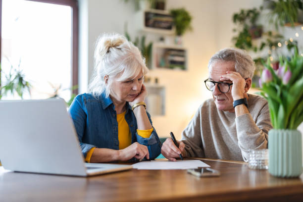 Senior couple sitting at the table discussing home finances
