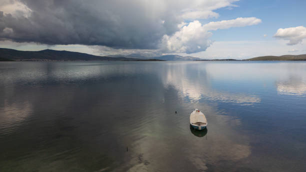 A small boat at beach of Urla, izmir. beautiful clouds