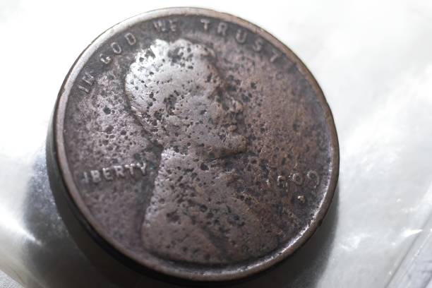 istock Closeup of an old coin on the white surface 2096502714