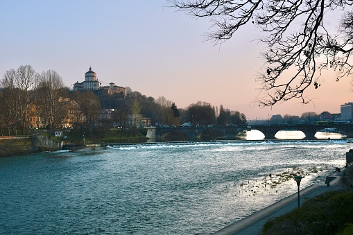 Turin view at sunset with Po river, bridge and Santa Maria al Monte church
