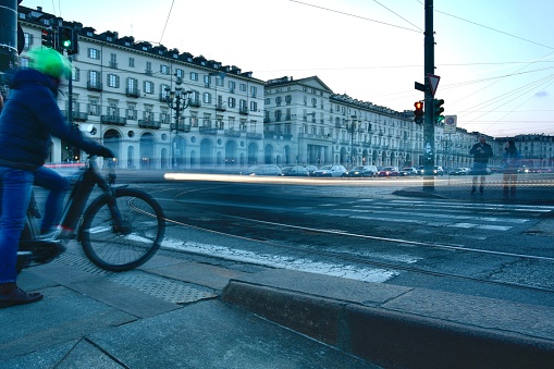 Cyclist waiting for green light to cross main street