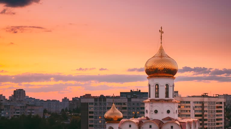 Bold Bright Yellow Orange Sky Backdrop. Summer Sunset Time Lapse. Soft Colors Sky Background. Time-lapse View On Church At Dusk Time. From Day To Evening Transition. Tranquility View. Religion Concept