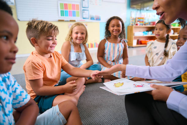 istock Female Primary Or Elementary School Teacher Gives Student High Five In Multi-Cultural Class 2096529745