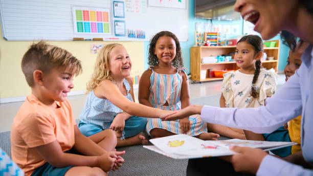 istock Female Primary Or Elementary School Teacher Gives Student High Five In Multi-Cultural Class 2096533724