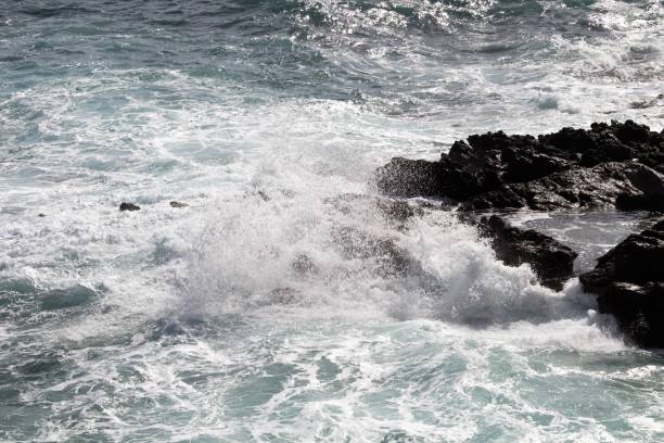 istock rough sea slamming against the rocks 2096576159