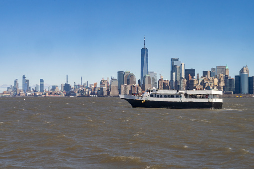 Manhattan skyline behind Liberty ferry in Hudson River.