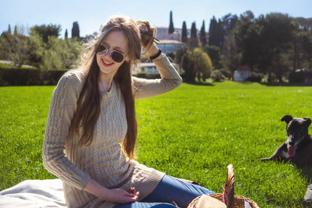 One young woman petsitting a greyhound for her friend