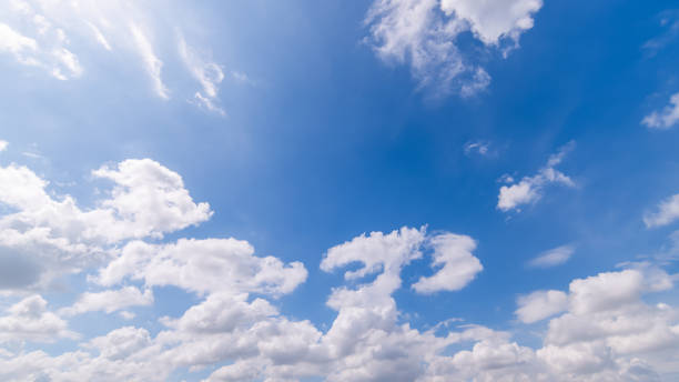 istock Panoramic view of clear blue sky and clouds, Blue sky background with tiny clouds. White fluffy clouds in the blue sky. Captivating stock photo featuring the mesmerizing beauty of the sky and clouds. 2096607930