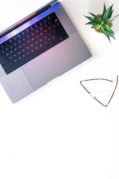 istock Laptop, glasses and flowerpot isolated on a white background. 2096610569