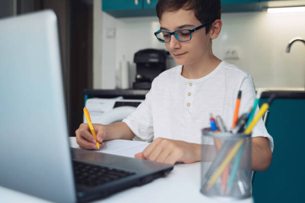 istock Studying from home. Teenager boy is Working on Homework for School. Education Concept 2096611110