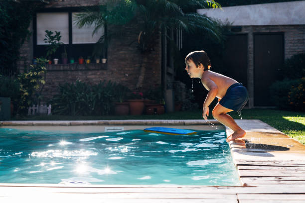 istock Little boy jumping in a pool. 2096611123