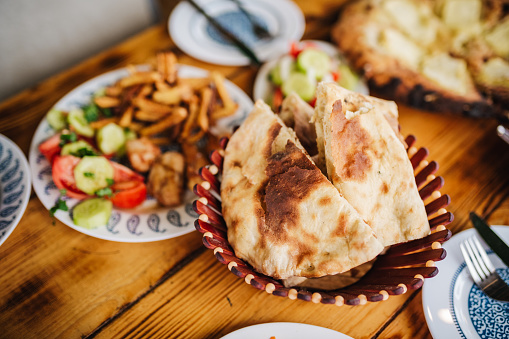 Georgian supper - called supra - on a wooden table. Assortment of appetizers and salads