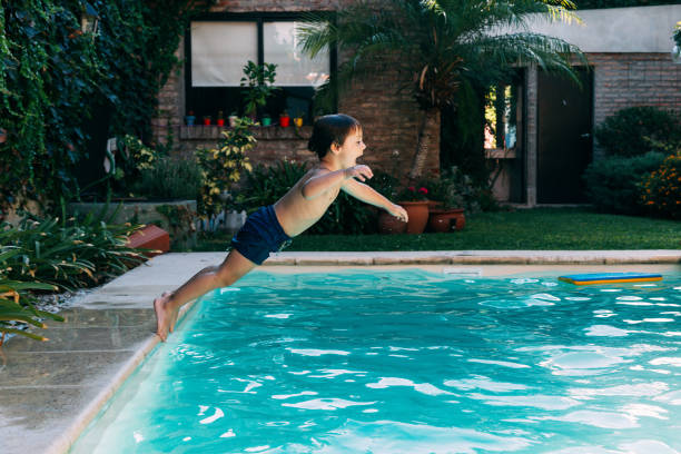 istock Little boy jumping in a pool. 2096613285