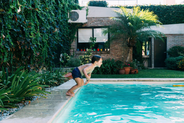 istock Little boy jumping in a pool. 2096613520