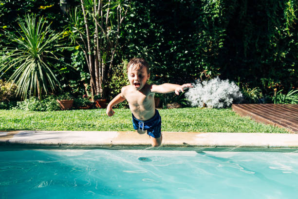 istock Little boy jumping in a pool. 2096618527