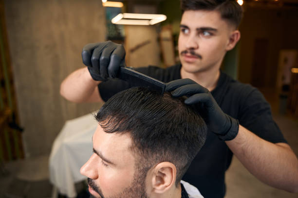 istock Man coiffeur making hairstyle for bearded customer 2096629706