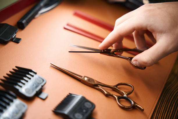istock Unrecognizable hair professional wielding barber's scissors in barbershop 2096629708