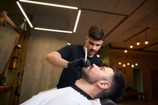 istock Barber master doing beard styling in barbershop 2096630820