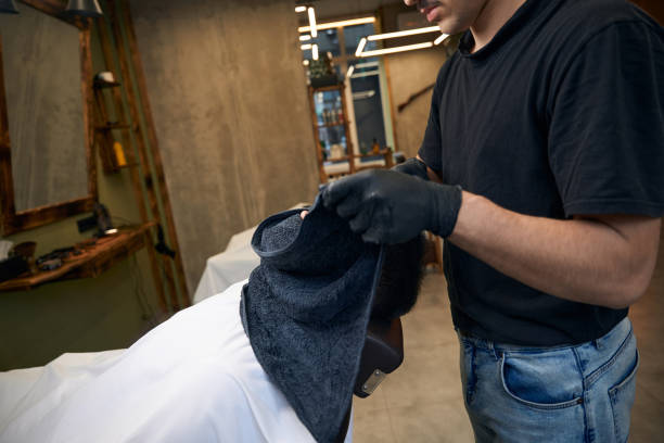 Man client visiting barbershop for styling and grooming his beard
