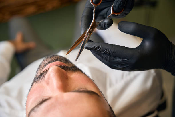 istock Beard styling and cut with scissors for man at barbershop 2096630870