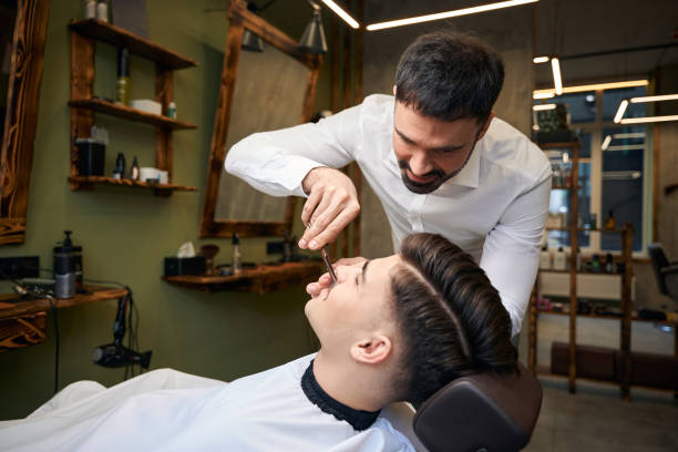 istock Professional barber making mustache hairstyle for man customer 2096631417