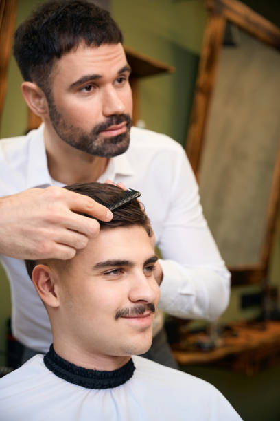 istock Man hairstylist serving client with mustache 2096631419