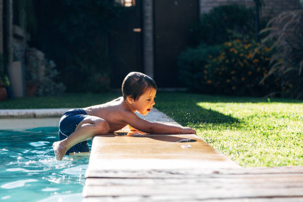 istock Boy getting out of the pool 2096634128