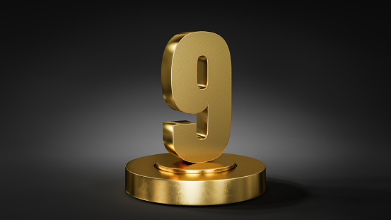 The number 9 on a pedestal / podium in golden color in front of dark background with spot light.