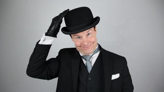 Kind Businessman Doffing Bowler Hat in Polite Greeting