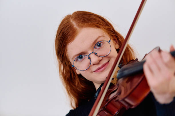 istock Redhead Musician Poses with Violin in Captivating Portrait 2096652306