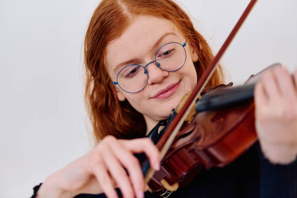 istock Redhead Musician Poses with Violin in Captivating Portrait 2096671286