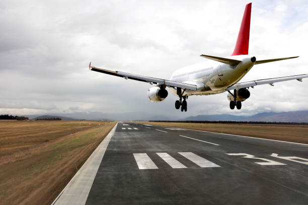 Passenger airplane landing at sunset