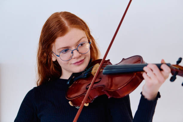 istock Redhead Musician Poses with Violin in Captivating Portrait 2096675558